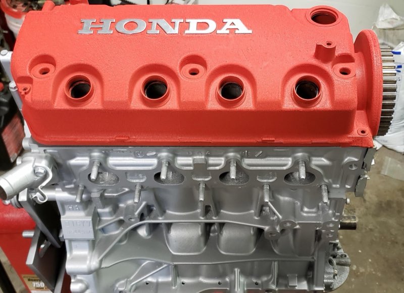 Rebuilt Honda engine with a red valve cover