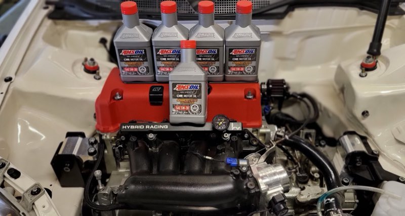 Performance engine bay build with a red valve cover